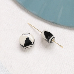 Macro shot of black and white marble pattern ceramic beads with glossy glaze finish