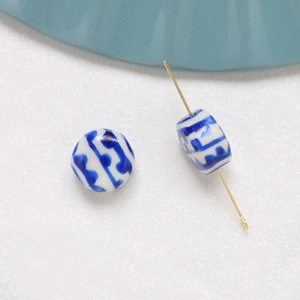 Detail of blue and white ceramic beads showing hole structure with a metal pin for jewelry DIY