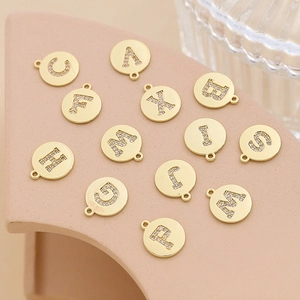 Detailed view of gold-plated alphabet charms with inlaid cubic zirconia for DIY jewelry