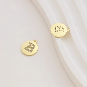 Macro shot of 18k gold-plated letter B pendant with micro-set cubic zirconia stones