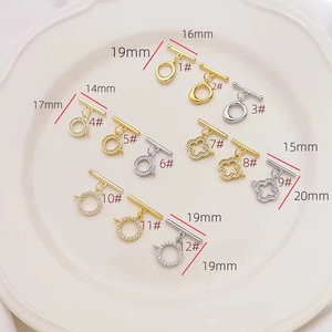 Detailed macro view of 18K gold and silver toggle clasps with zircon micro-pave for DIY jewelry