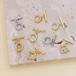 Macro detail of gold and silver plated OT clasps with micro-set cubic zirconia stones