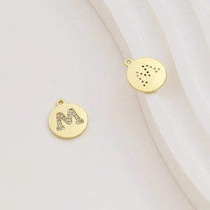 Detail of 18k gold plated letter M pendant with cubic zirconia for DIY jewelry making