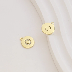 Detailed view of 18k gold-plated round charm with cubic zirconia for DIY jewelry making