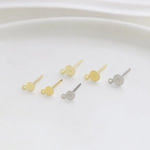 Close-up of gold and silver plated flat stud earring posts with loops for DIY jewelry