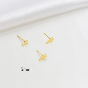 Detailed view of 5mm gold plated earring posts with flat pads for DIY jewelry making
