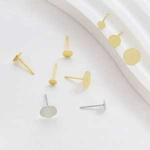 Flat round gold and silver earring studs DIY jewelry making parts on white stand