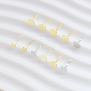 Close-up of gold and silver plated flat stud earring posts for DIY jewelry making