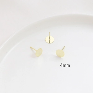Macro detail of 4mm gold-plated earring studs for DIY jewelry with S925 silver pins