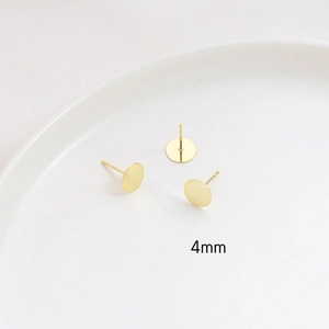Macro detail of 4mm gold-plated flat stud earring posts for DIY jewelry making