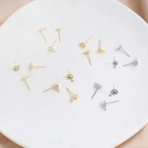 DIY Ohrstecker-Zubehör mit Schalenstecker in Gold und Silber auf einem Keramikteller