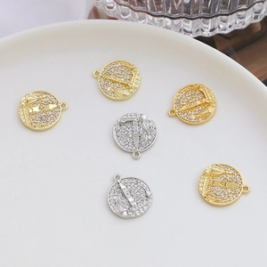 Detailed macro view of gold and silver coin pendants with pavé zircon Big Ben design