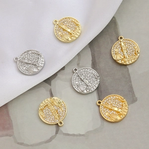 Detailed view of gold and silver castle pendants inlaid with sparkling cubic zirconia
