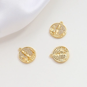 Detailed view of three gold-plated castle pendants with white zircon pavé for DIY jewelry