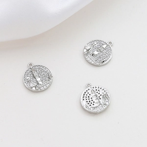 Detailed close-up of castle pendants with micro-pave zircons and silver plating