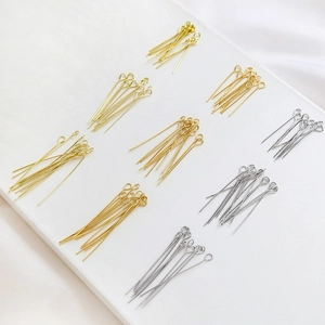 Detailed view of gold and silver eye pins for DIY jewelry making accessories