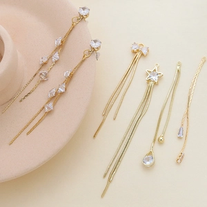 Pendentifs nœud papillon dorés avec pampilles et zircons pour fabrication de bijoux