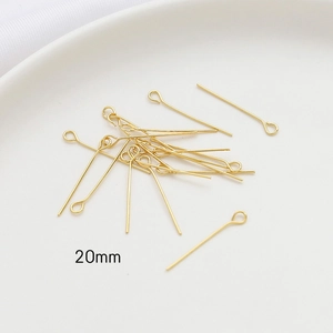 Detailed close-up of 20mm 14k gold-plated eye pins for DIY jewelry making and crafts