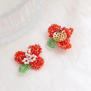 Macro detail of handmade crystal flower beadwork with a golden filigree metal base