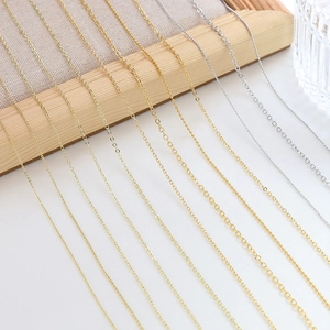Macro shot of 14k gold-plated jewelry chains in various styles like O-chain and bead links
