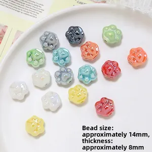 Macro shot of 14mm ceramic cat paw beads with colorful pearlescent finish for DIY jewelry