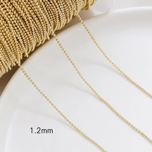 Macro detail of 1.2mm 14k gold plated beaded chain for DIY jewelry making and necklaces