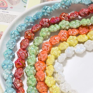 Close-up of colorful cat paw ceramic beads with pearlescent glaze for DIY jewelry making