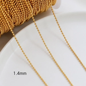 Close-up of 1.4mm gold plated ball chain on a white plate for DIY jewelry making
