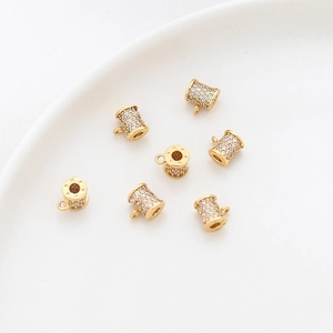 Detail of 14k gold-plated cylinder spacer beads with pavé cubic zirconia for DIY jewelry
