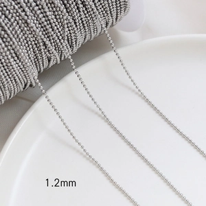 Detail of 1.2mm silver bead chain on white ceramic for DIY jewelry making accessories
