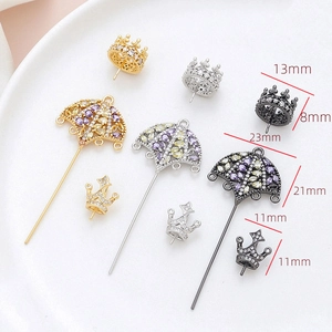 Macro detail of crown and umbrella jewelry pendants with zircons for DIY accessory making
