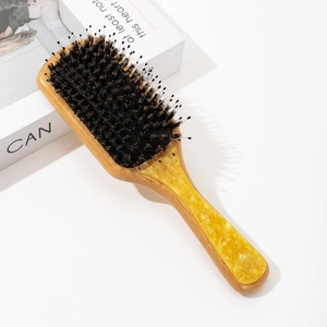Close-up of bamboo hairbrush with acetate marble inlay and black boar bristles