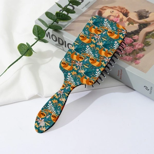 Detailed view of sloth and floral print paddle hairbrush on a cozy background