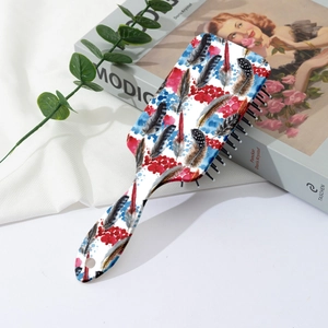 Detail of colorful feather print hair brush with ergonomic handle on aesthetic background