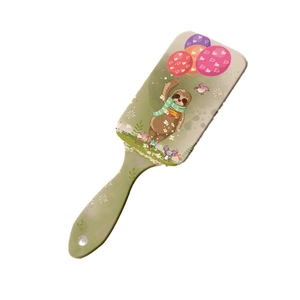 Green air cushion hairbrush featuring cute cartoon sloth print for scalp massage