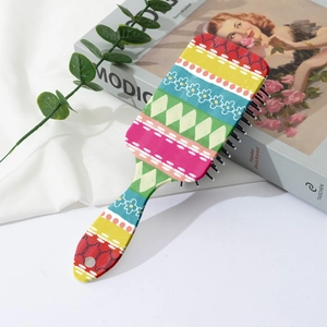 Close-up of colorful Bohemian floral print on a paddle hairbrush with black massaging pins