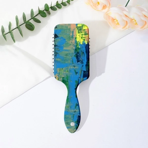 Detail of artistic graffiti cushion hair brush with colorful abstract pattern on back