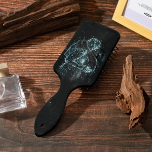 Starry sky art print hair cushion brush with massage bristles on wood background