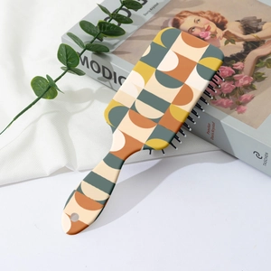 Detail view of air cushion hairbrush with vintage geometric patterns and round hanging hole