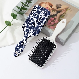 Floral print paddle hairbrush with blue rose pattern and massage cushion bristles