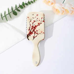 Detail of floral air cushion hairbrush with red plum blossom and bird print on back