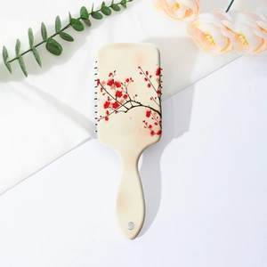 Close-up of plum blossom print on air cushion hair brush with vintage floral patterns