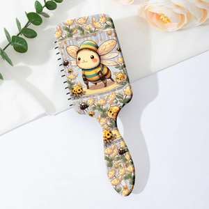 Brosse à cheveux massante avec motif abeille et fleurs sur fond en tissu blanc