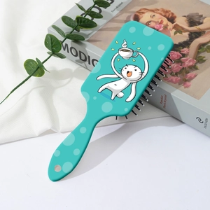 Vue détaillée d'une brosse à cheveux chat vert avec coussin d'air et motifs à pois