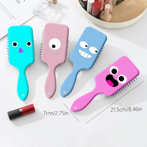 Set of four cute monster hair brushes with cartoon big eyes and scalp massage bristles