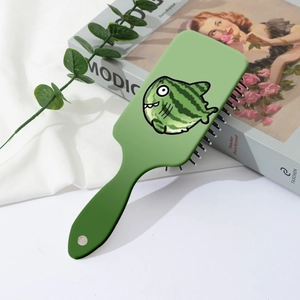 Detail of green air cushion hairbrush featuring a cute watermelon fish pattern design