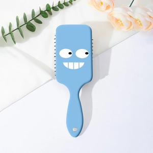 Detail of light blue air cushion brush with funny big eyes and mouth cartoon design