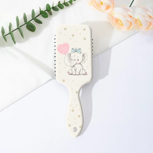 Détail d'une brosse à cheveux à coussin d'air avec motif éléphant et pois mignons