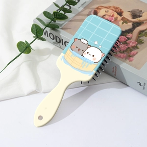 Close-up of cute cartoon cat pattern on blue and yellow air cushion hairbrush
