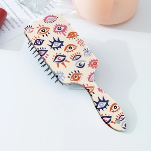 Brosse à cheveux pneumatique à motif œil avec design pop art coloré et coussin doux